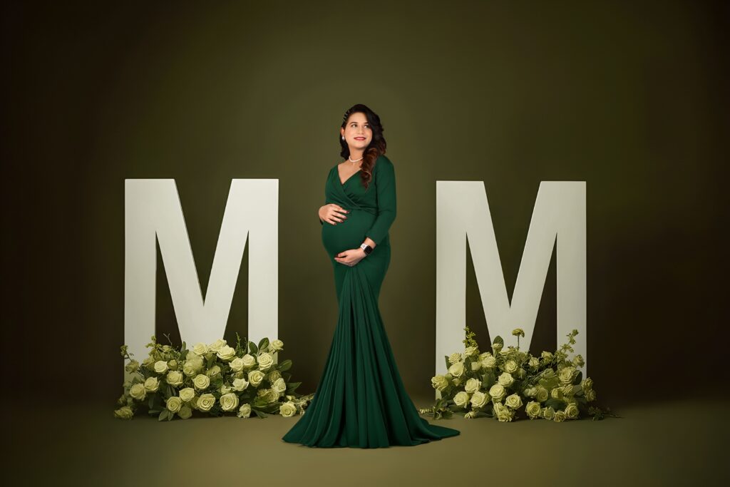 Current image: Premium maternity photoshoot at MatBaby Pictora studio in Nagpur featuring elegant baby bump portrait with professional lighting and designer gown.