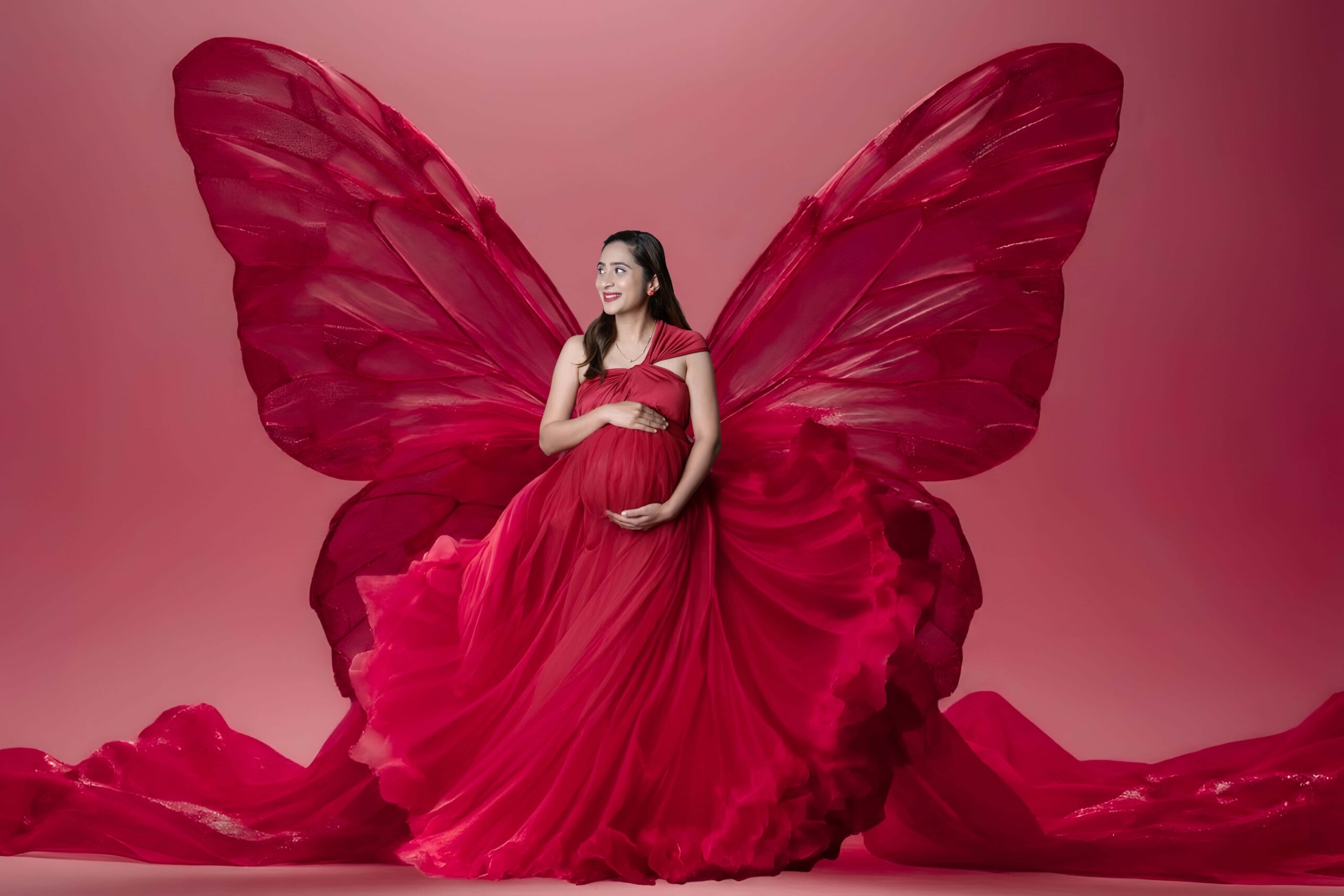 Premium maternity photoshoot at MatBaby Pictora studio in Nagpur featuring elegant baby bump portrait with professional lighting and designer gown