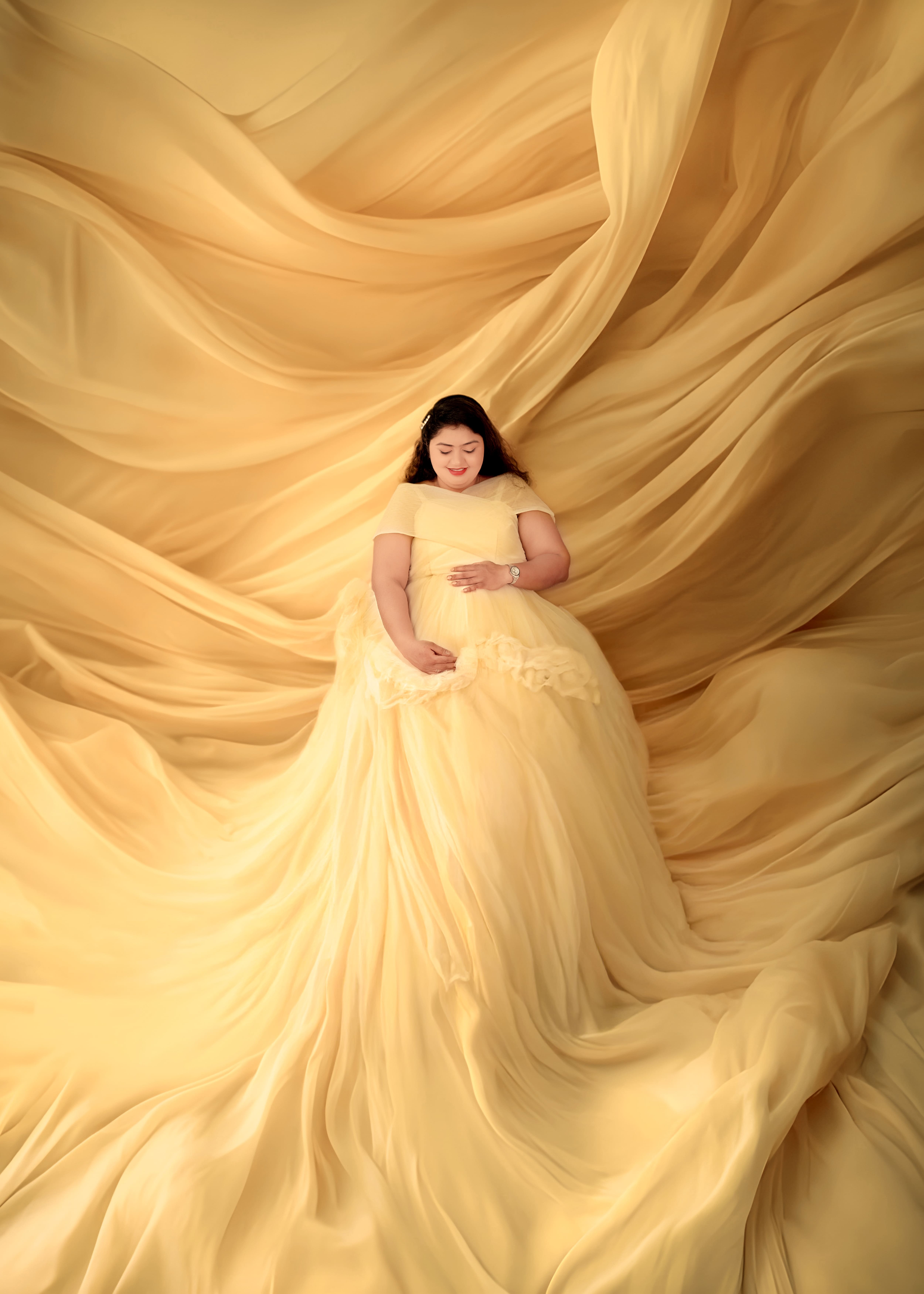 Premium maternity photoshoot at MatBaby Pictora studio in Nagpur featuring elegant baby bump portrait with professional lighting and designer gown.
